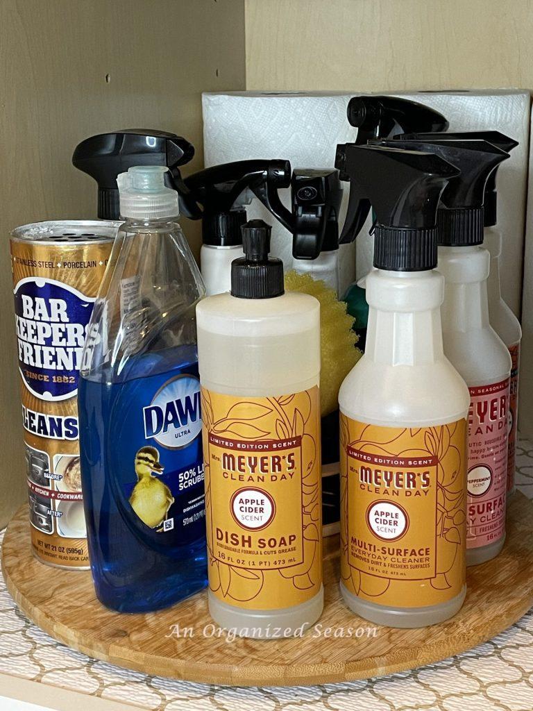 Using a Lazy Susan to store cleaning products under the sink is a  helpful kitchen cabinet organization solution!