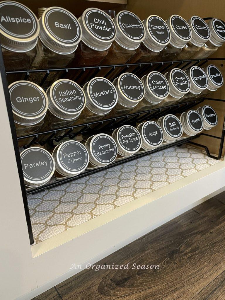 Purchasing a spice rack is a helpful kitchen cabinet organization solution.