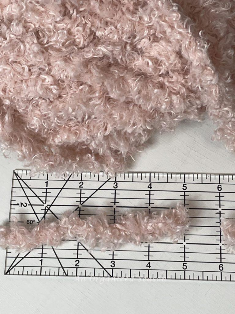 Cut five inch strips of Teddy Bear yarn to craft a Valentine's heart wreath.