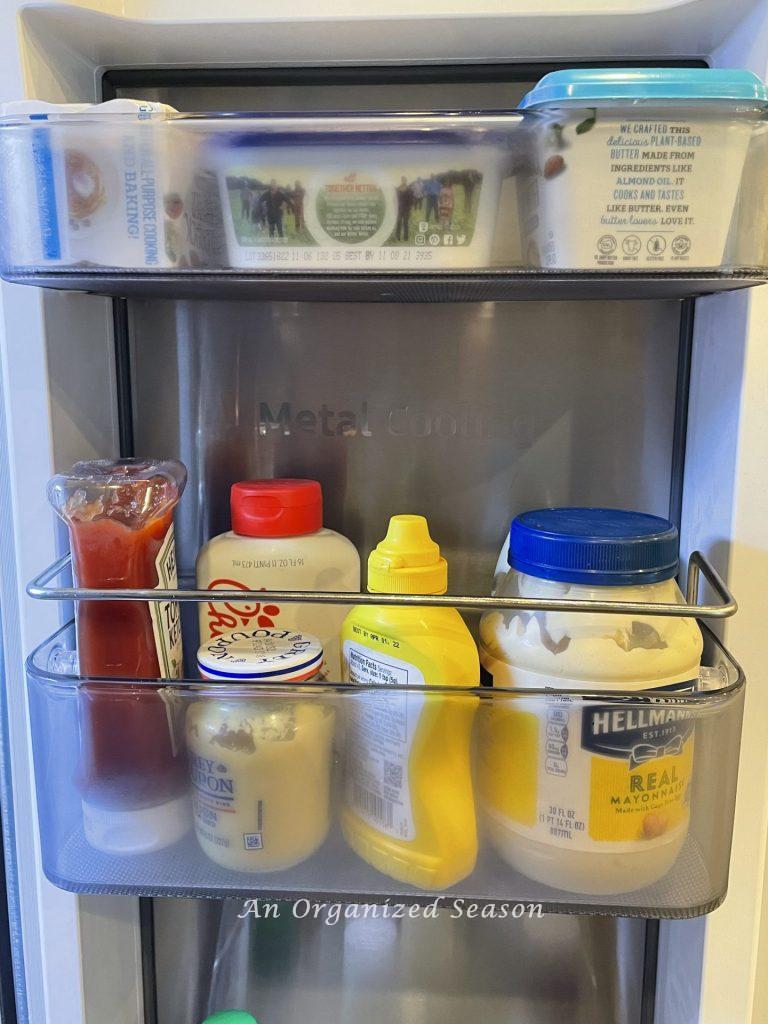 Organize all of your condiments in one bin inside your refrigerator. 