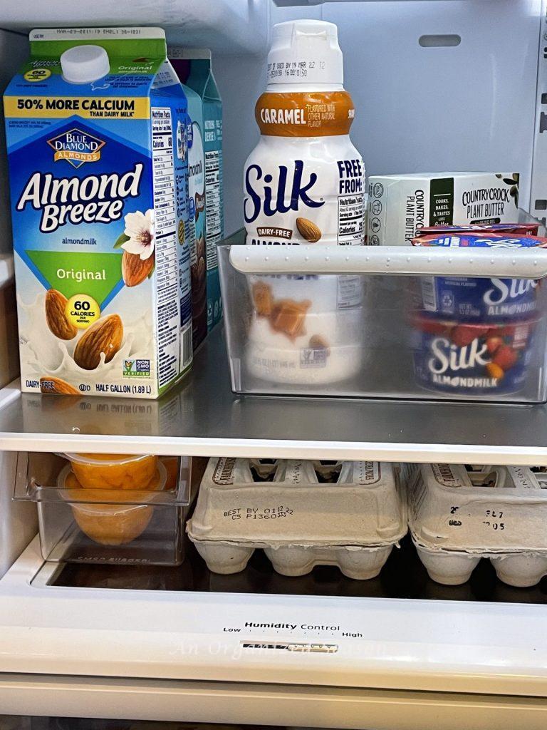 How to organize dairy products in a bin to corral them inside a refrigerator. 