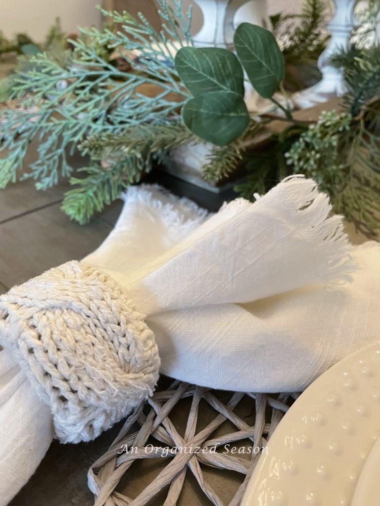 A napkin holder made form a sweater showing how to decorate a home for Winter.