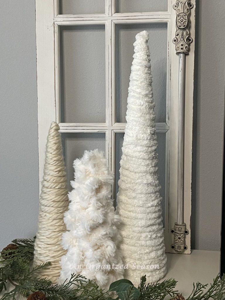 Three yarn cone trees used to decorate a home for winter.