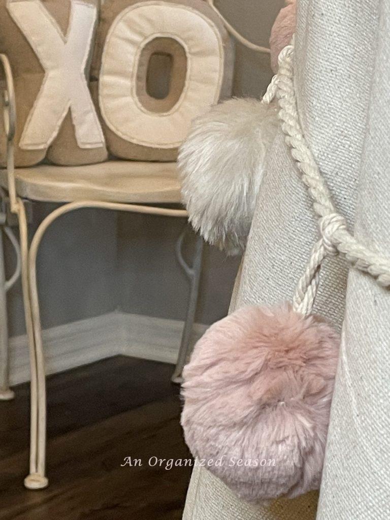 A faux fur garland draped on a table as an example of table decor for Valentine's Day.