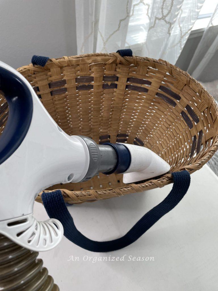 A basket being vacuumed clean to make a floral basket wreath.