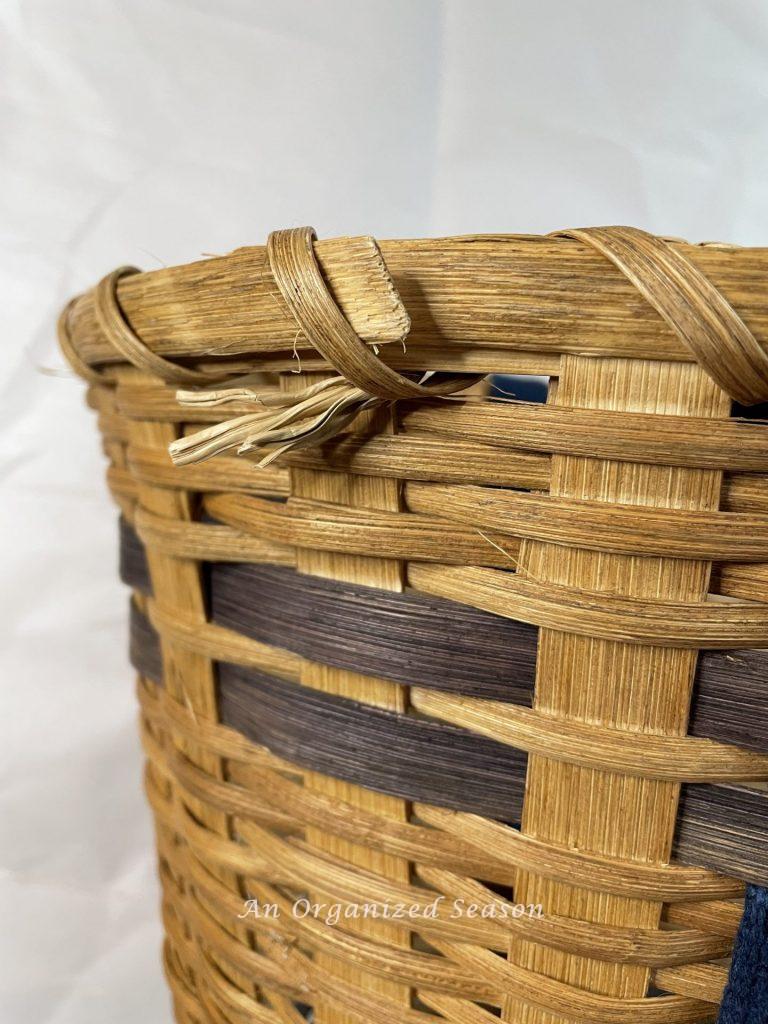 A basket with frayed pieces that need to be repaired before you can make a floral basket wreath.