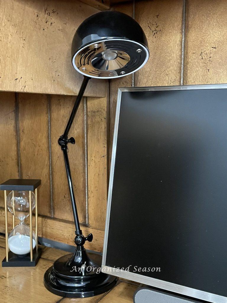A desk lamp sitting next to a computer showing ideas to organize a desk.