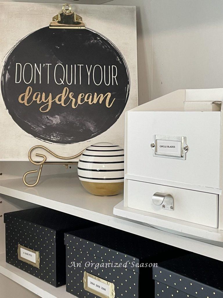 A white lazy Susan containing small scrapbook supplies, an example of ideas to organize a craft space.