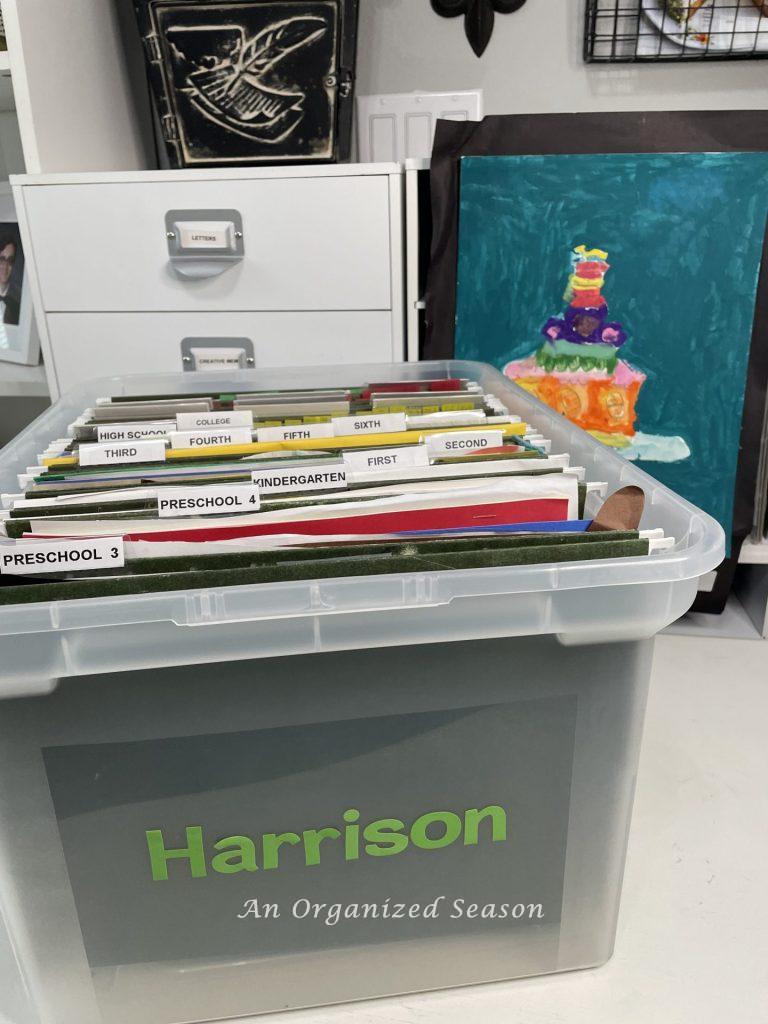 A plastic tub full of school files showing how to get rid of paper clutter.