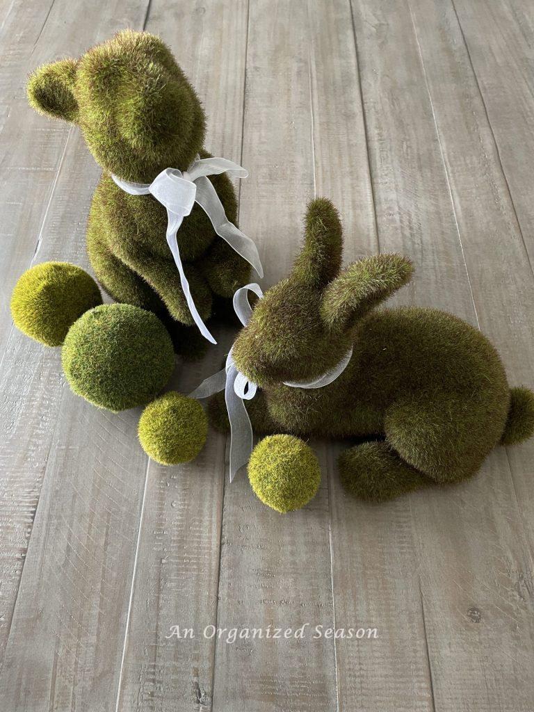 Two moss covered bunnies and spheres, my inspiration for my nature-inspired Easter tablescape.