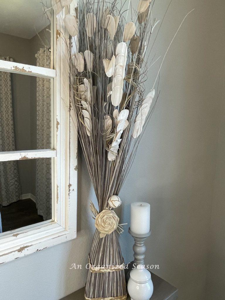 A gray and white dried flower arrangement that is the inspiration to  create a wood flower wreath.