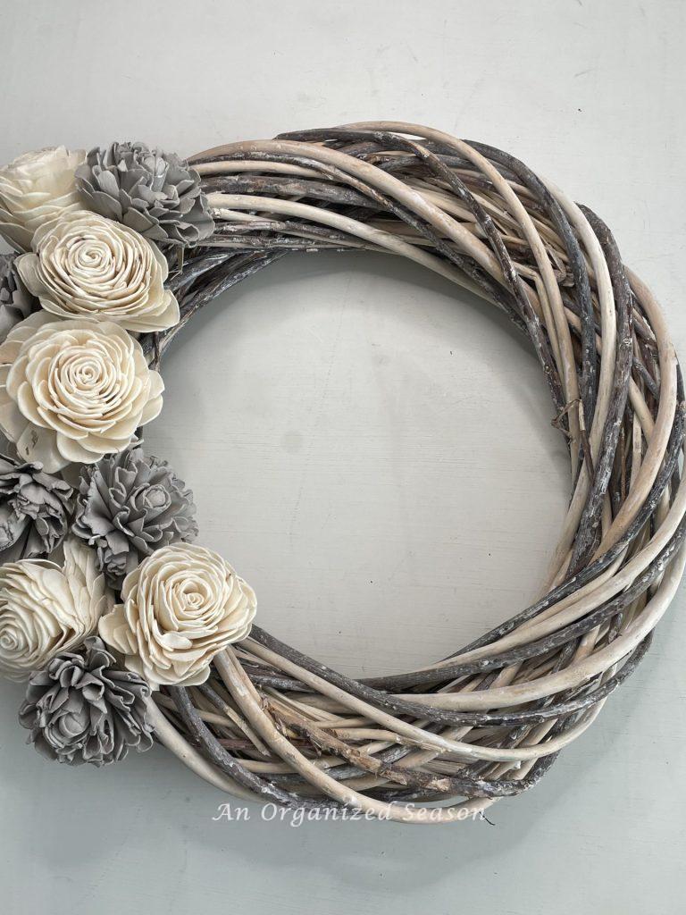 The finished gray and white wood flower wreath.
