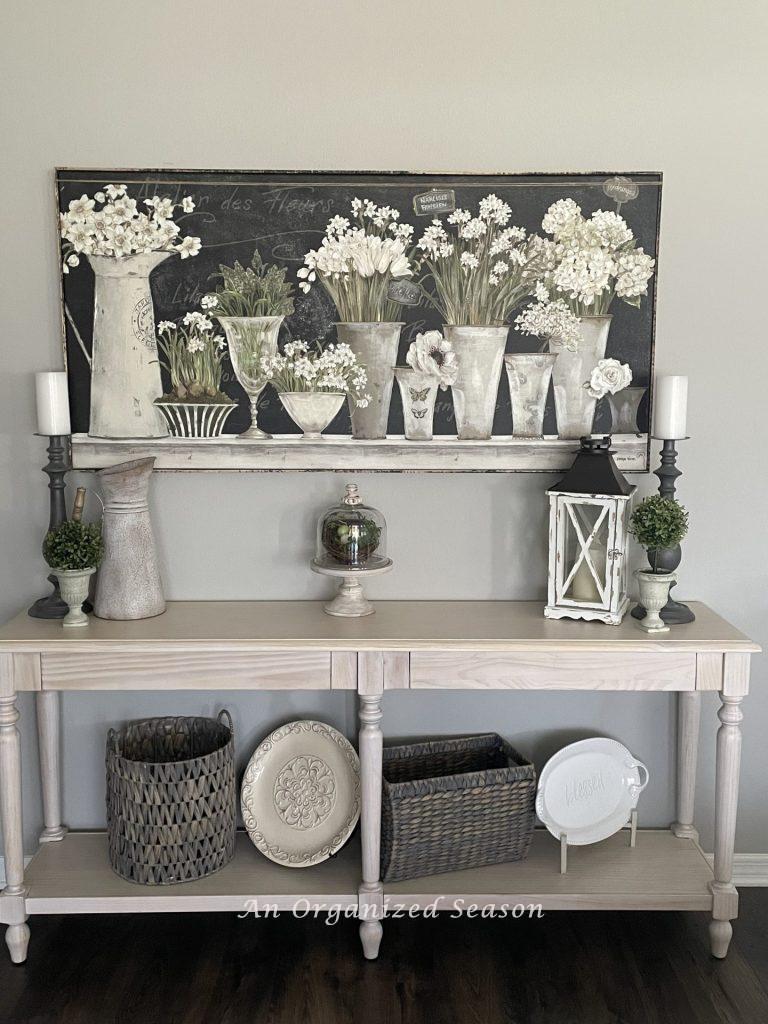 Picture of white spring flowers arranged in silver buckets, showing ideas to decorate your home for Spring.