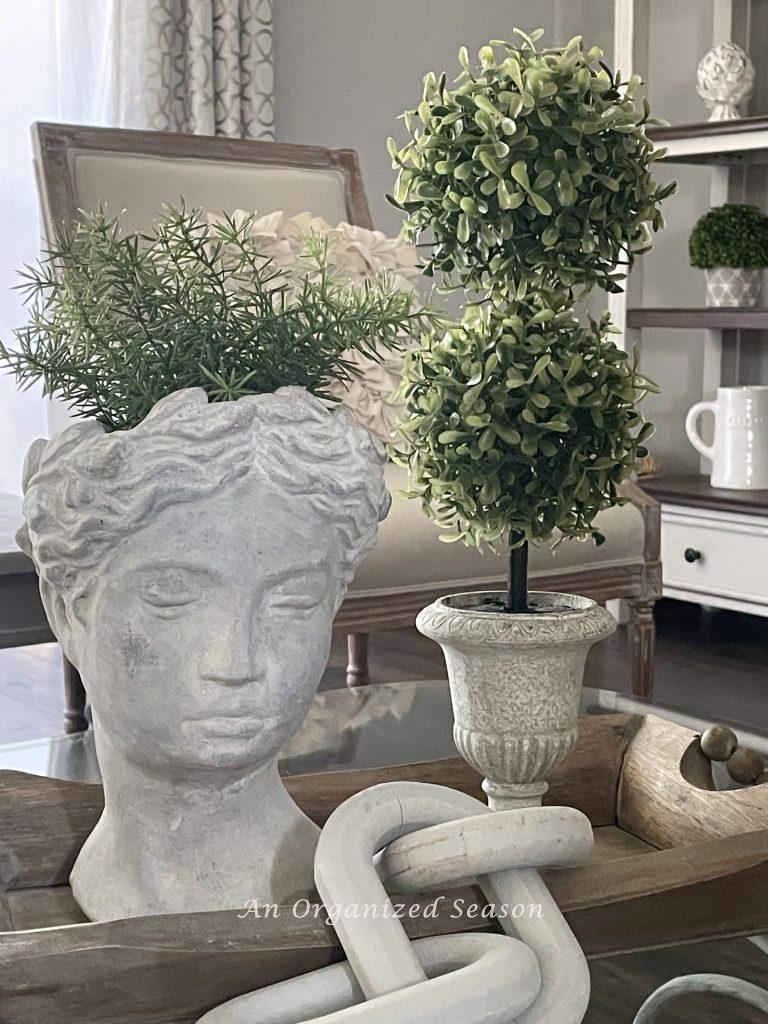 A bust planter and topiary vignette, an example of ideas to decorate your home for Spring.
