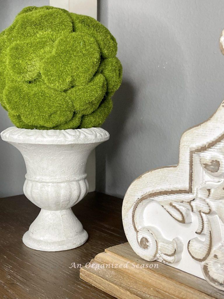 A moss topiary in a white urn, an idea to decorate your home for Spring.