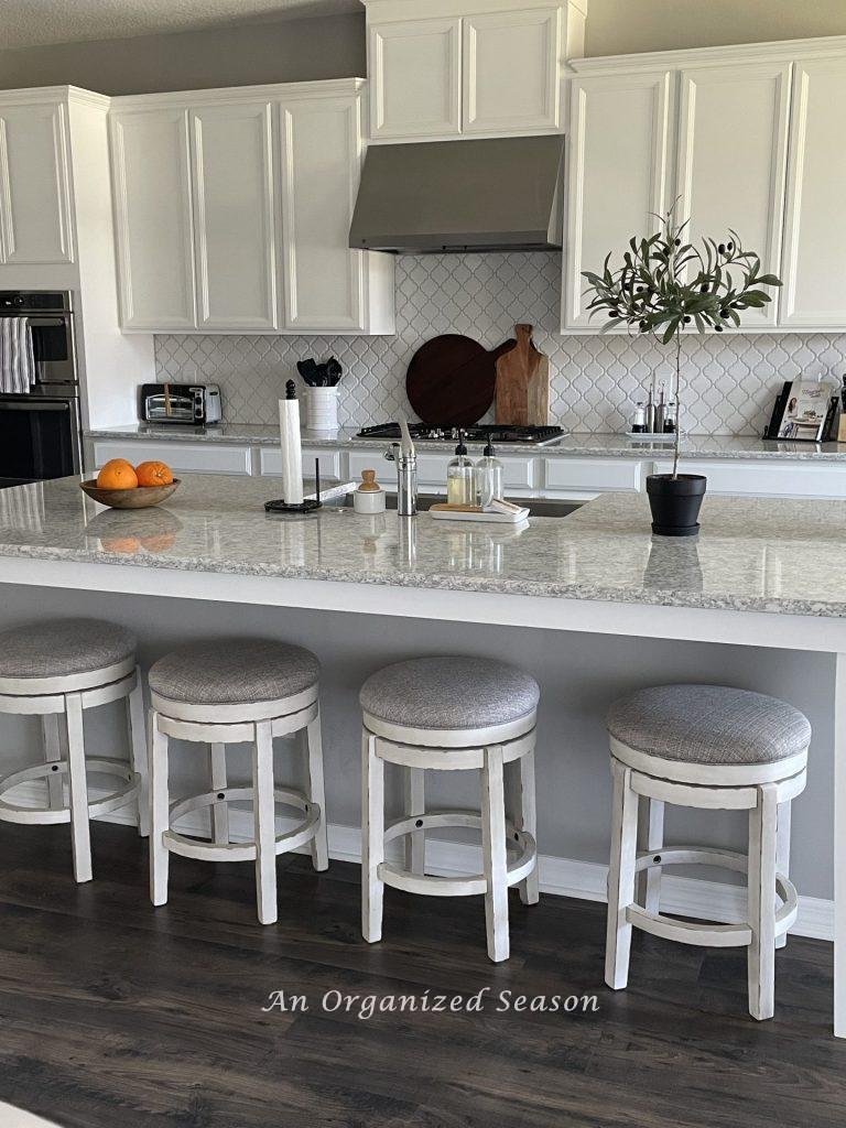 An olive topiary sitting on a kitchen counter, an idea to decorate your home for Spring.