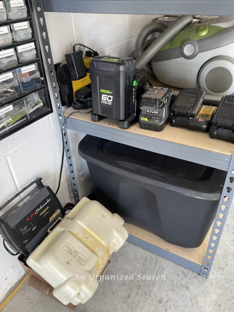 A battery charging station on a shelf in a garage. Showing how to organize a garage into zones.