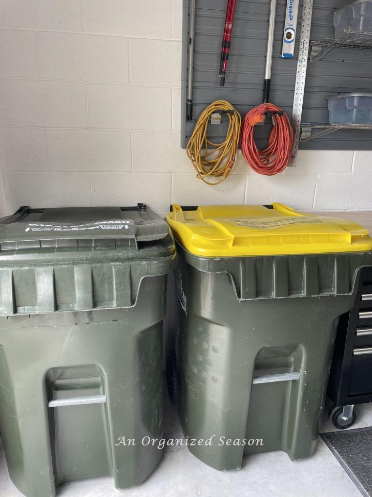 Trash and recycle cans in a garage. Showing how to organize a garage into zones.