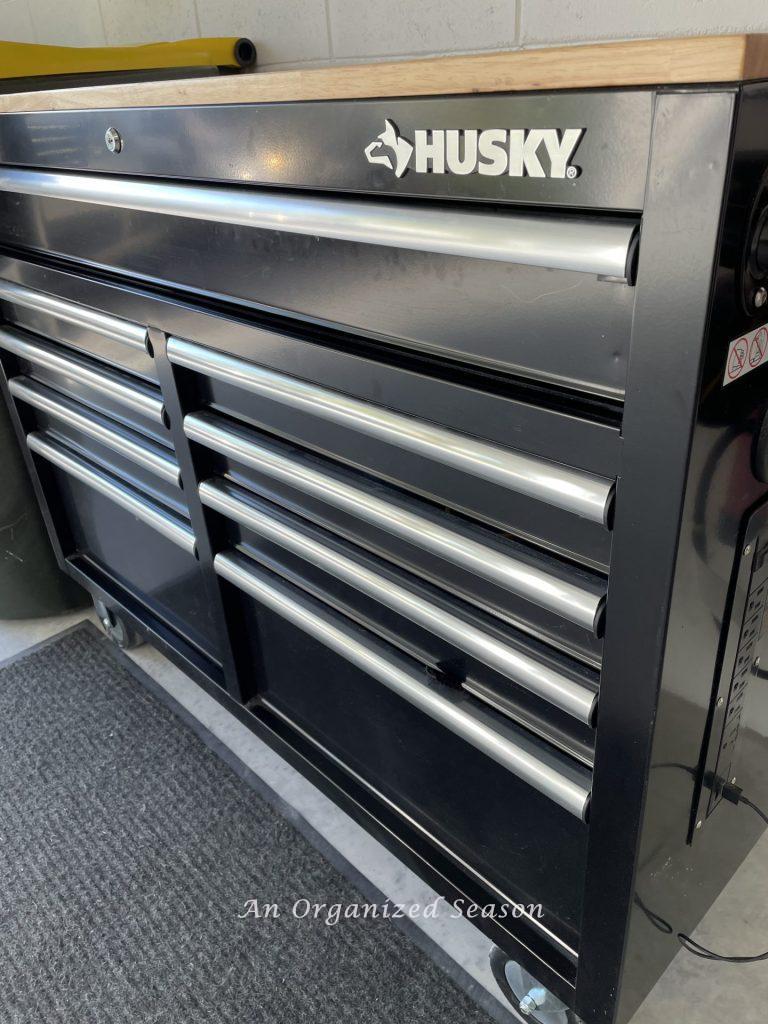 A black Husky workbench in a garage. Showing how to organize a garage into zones.