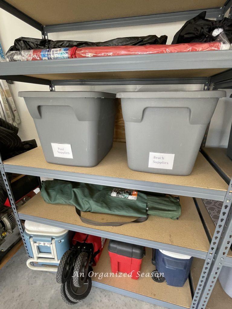 Shelves in a garage storing beach and pool supplies. Showing how to organize a garage into zones.