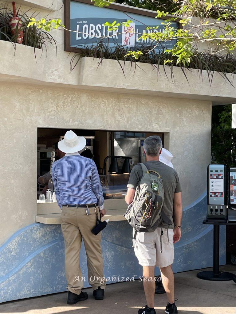 Man carrying backpack suggested in the amusement park ultimate packing list.