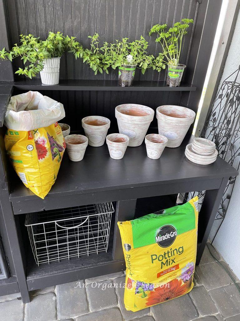 A place to store garden supplies, one of five reasons to have an outdoor potting bench.