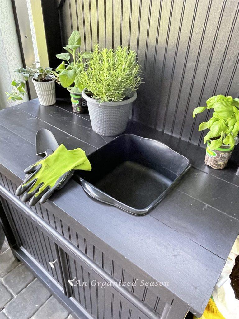 A potting bench with plastic tub build -in contains mess when planting, number two of five have an outdoor potting bench.