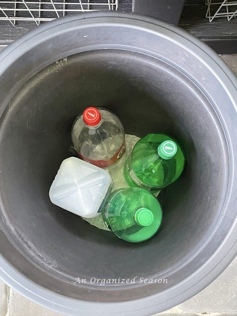 Put plastic bottles in bottom of a large flower pot, one of my simple tips to plant containers.