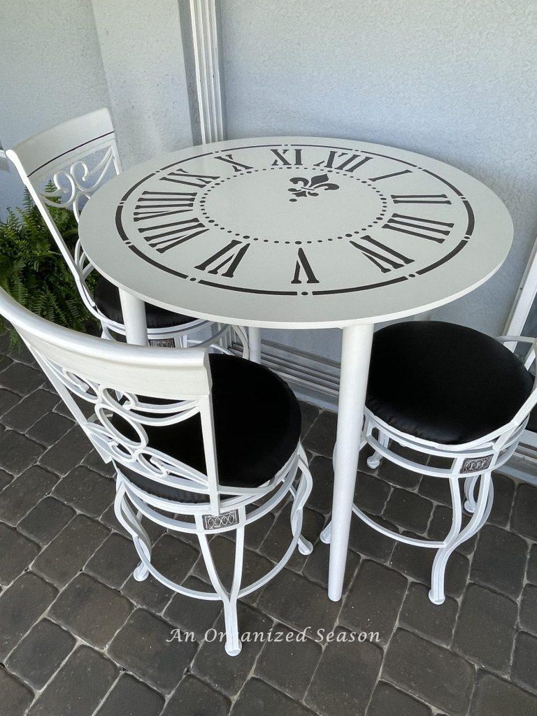 A black and white table set with a clock face stencil. 