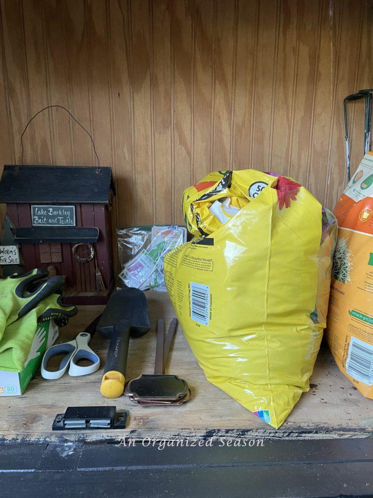 Gardening supplies storage, one of 5 reasons to have an outdoor potting bench. 