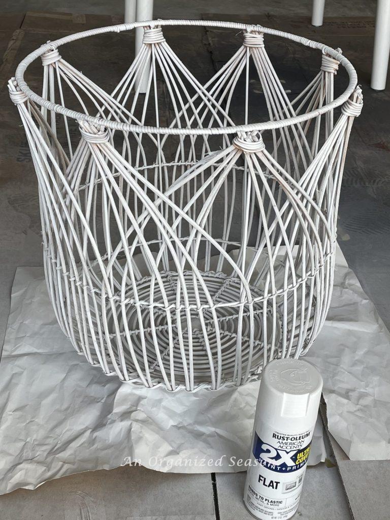 Step six for how to turn a woven basket into a light fixture is to spray paint the basket.