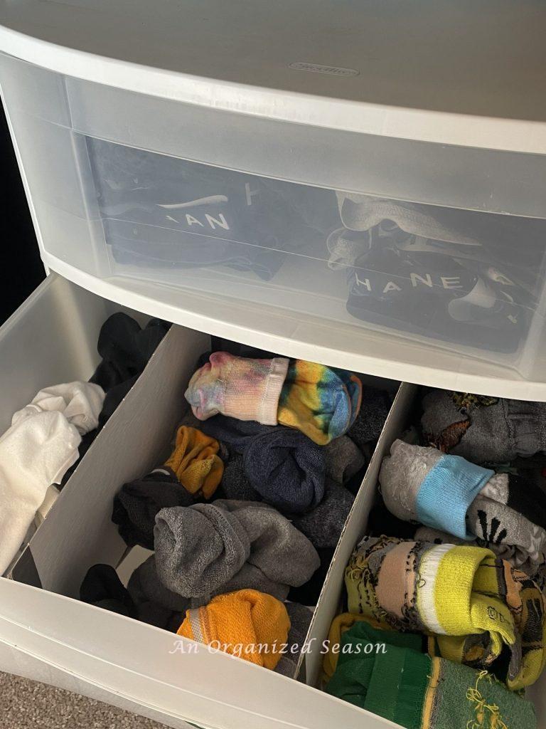 Organized socks in a drawer are an example of how to teach your kid how to organize a closet.