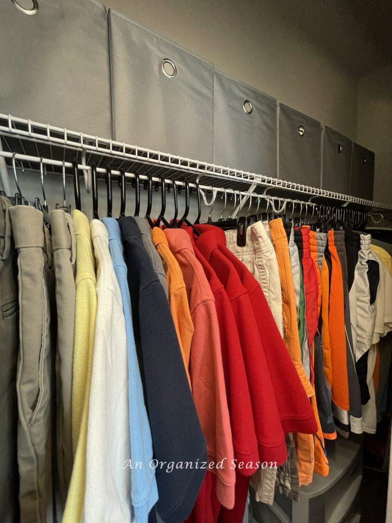 Storage bins on a closet shelf, an example of how to teach your kid how to organize a closet.