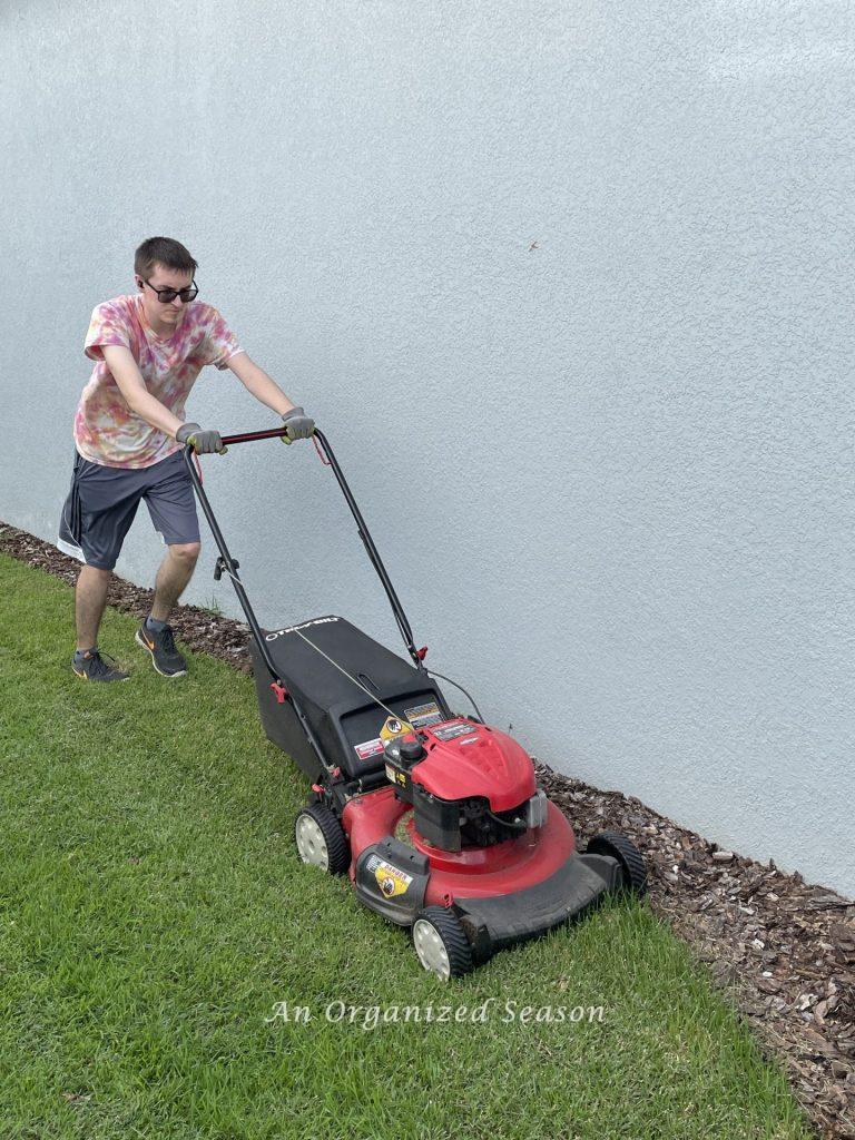 A son mowing the grass for his dad on Father's day.