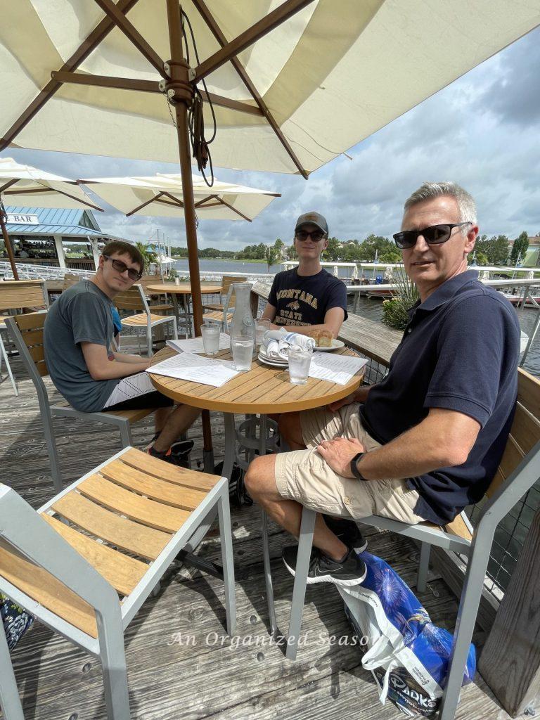 A dad eating lunch outdoors with two sons on Father's Day.