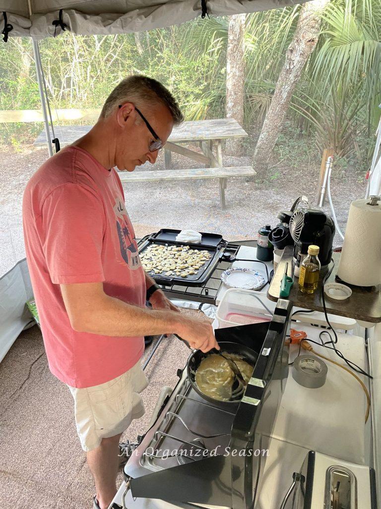 A dad cooking breakfast outdoors on Father's day.