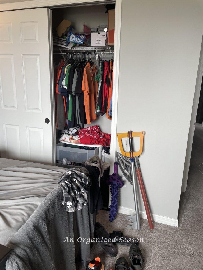 A cluttered closet showing why you should teach your kid how to organize a closet.