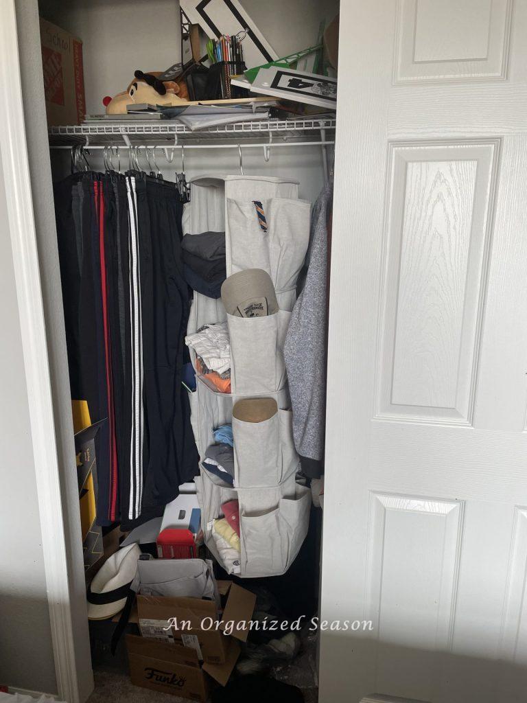 A messy closet showing why you should teach your kid how to organize a closet.