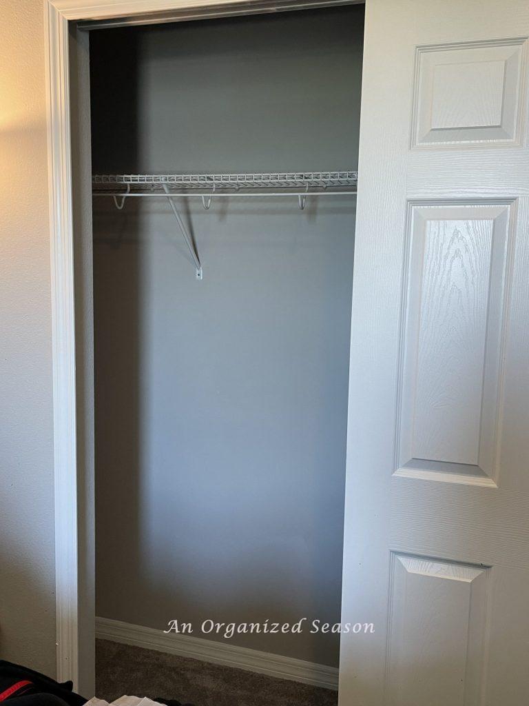 An empty closet, step two in how to teach your kid how to organize a closet.