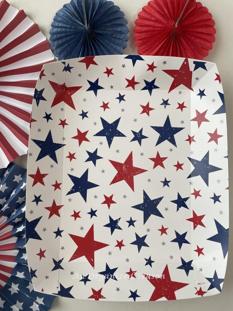 A white paper tray with red and blue stars is perfect to  make a bang with a 4th of July gift tray! 