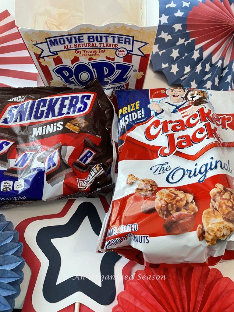 Popcorn, Snickers, and Cracker Jacks will  make a bang in a 4th of July gift tray! 