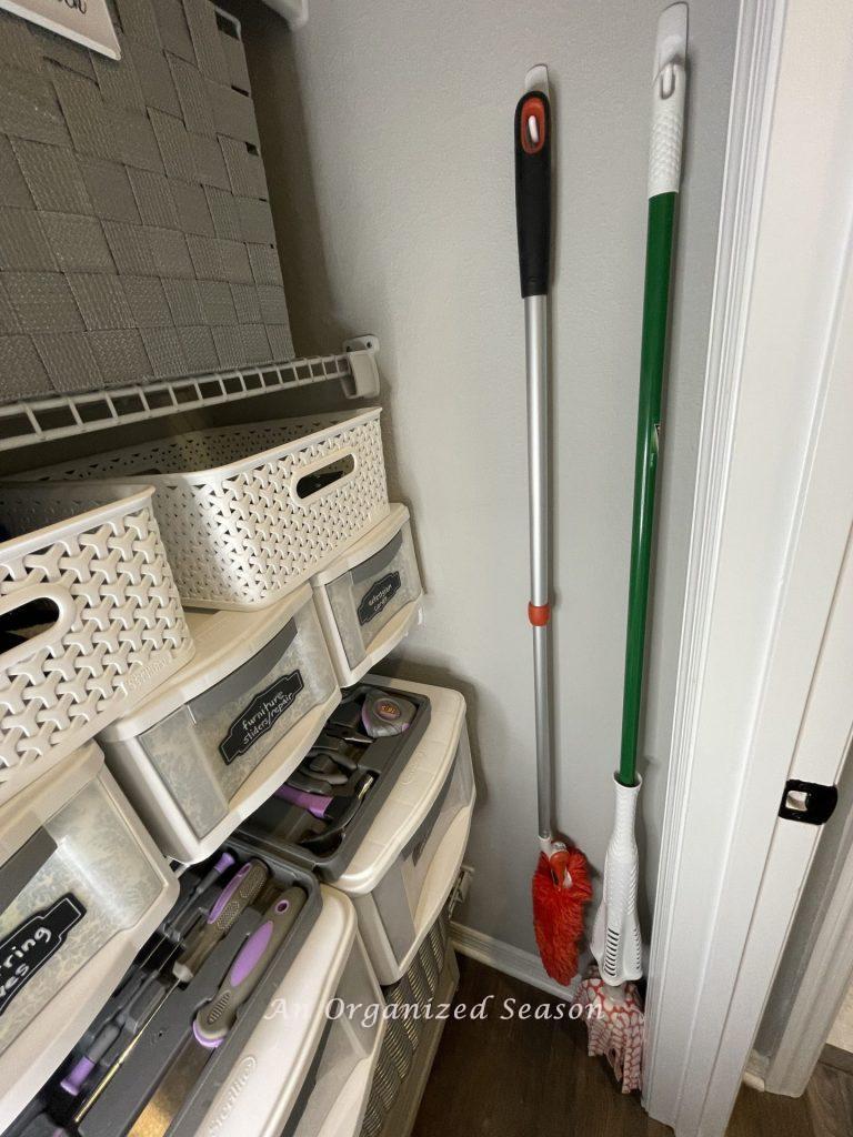 Hang brooms to use vertical space to  organize cleaning supplies to make house work easy! 