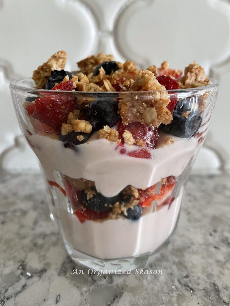 A yogurt parfait with strawberries and blueberries, showing part of my morning routine.