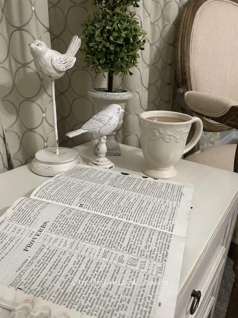 A table with an open Bible and cup of copy showing step 2 of my morning routine! 