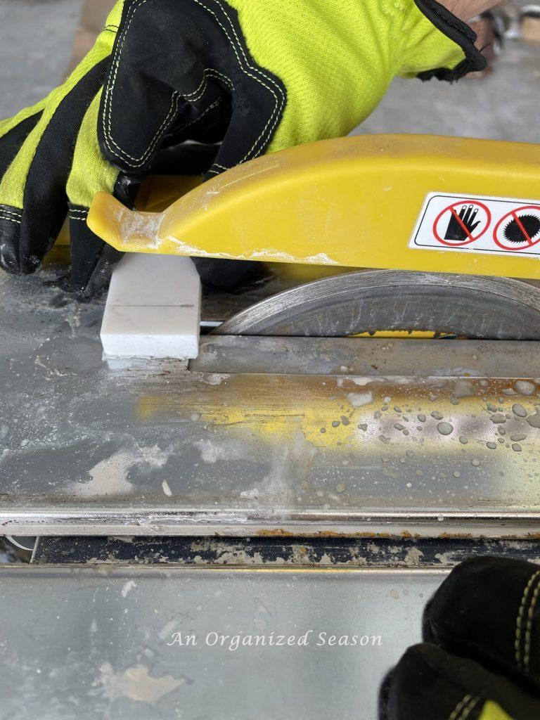 Cut the tiles with a wet saw before you tile over the existing tile.