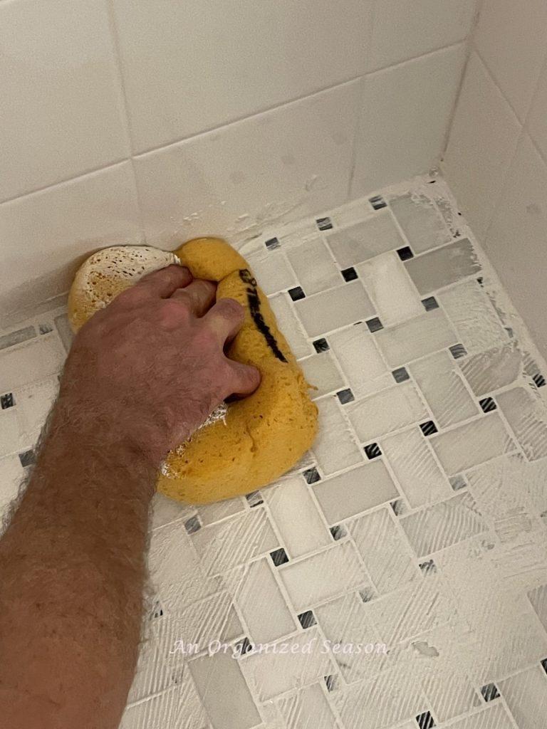 Wipe grout away with a sponge when you tile over the existing tile.