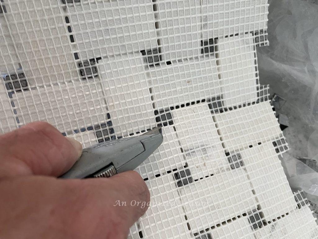 Cut the mesh of the tile sheet before you tile over the existing tile.