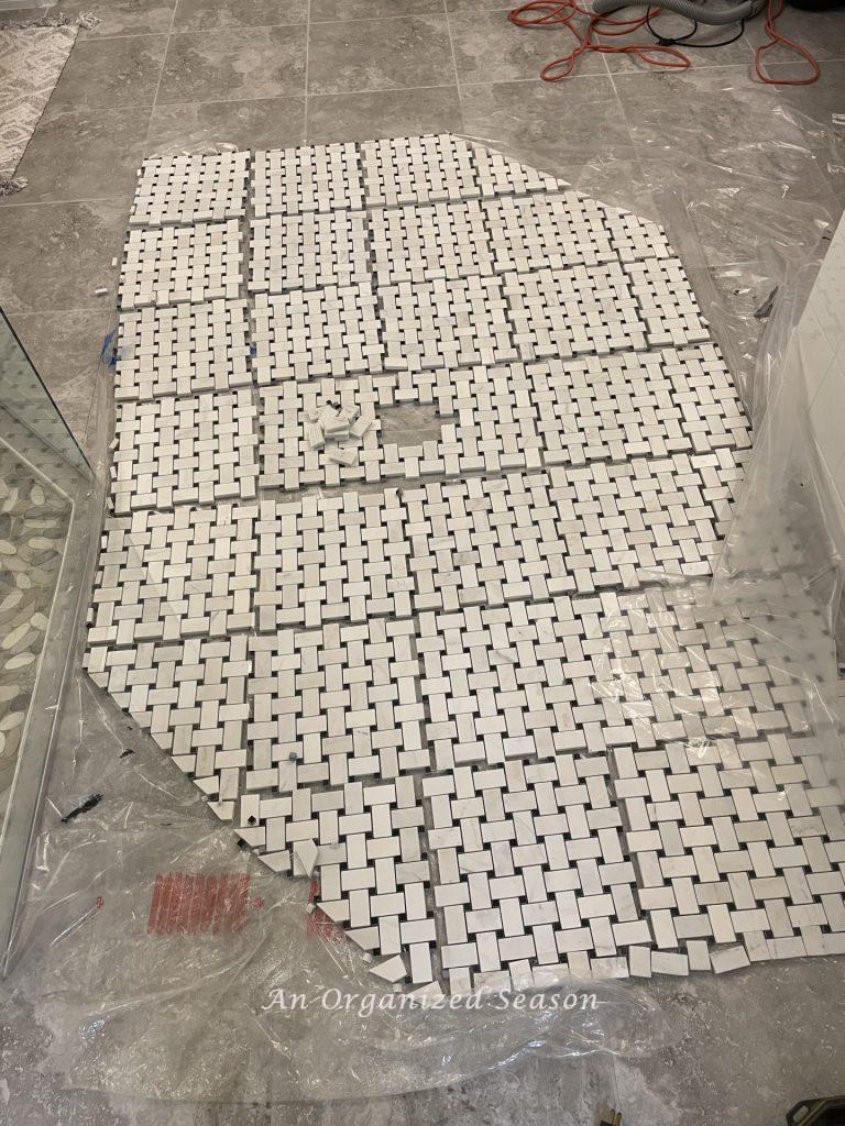 Lay out the cut pieces of tile on the floor before you tile over the existing tile.