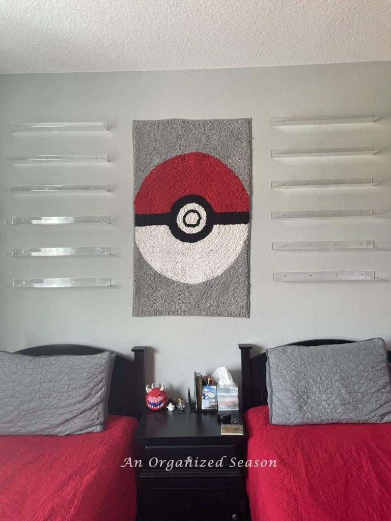 Six clear shelves hanging above twin beds show tips to organize collections in a kid's bedroom!