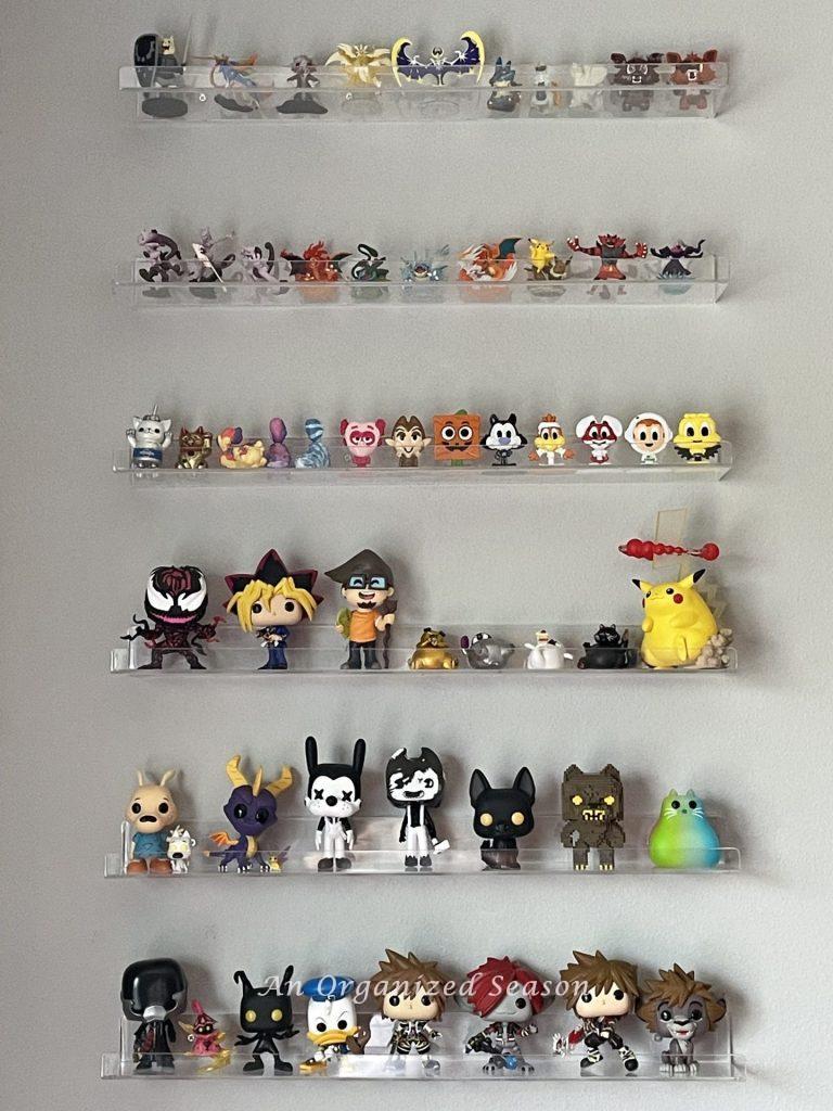 Six clear shelves displaying figurines. 